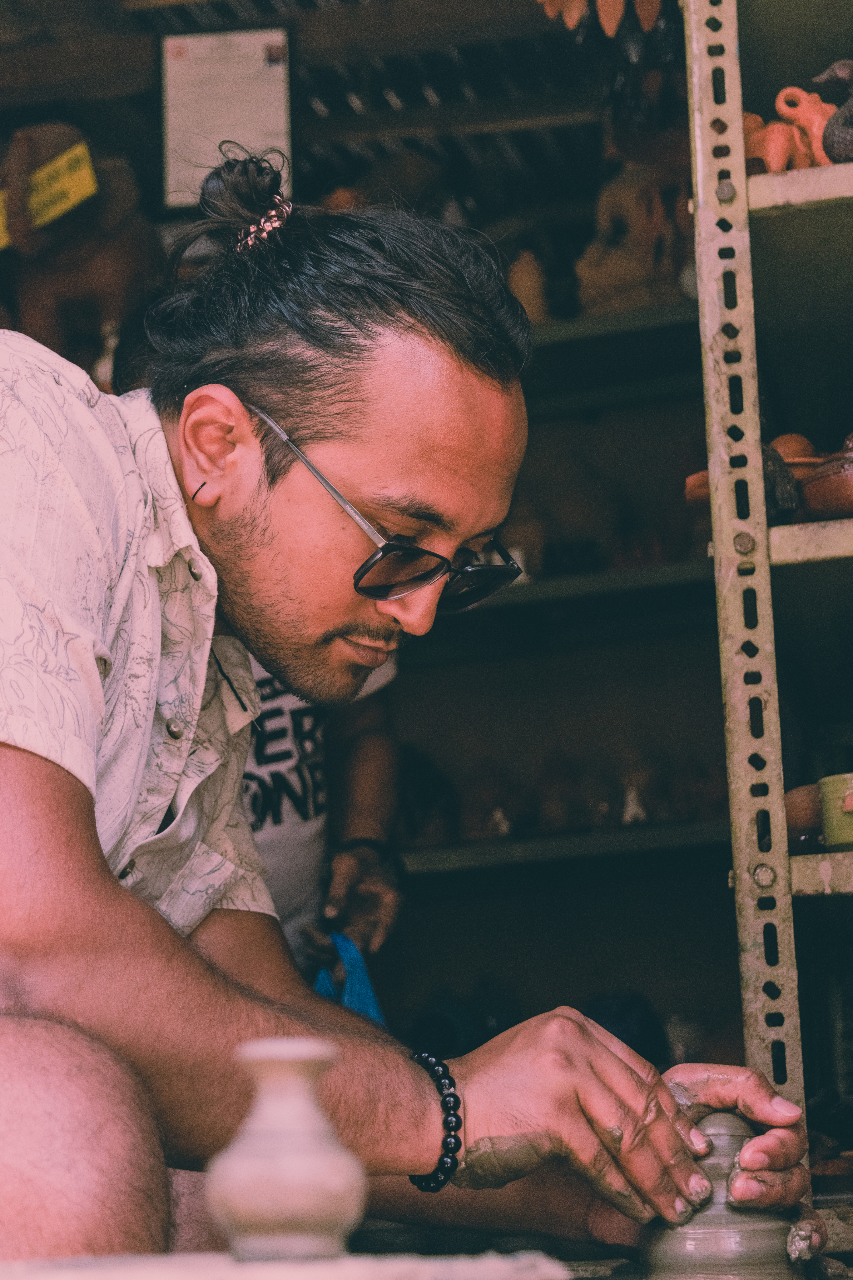 A picture of me wheel throwing little decorative pots in Bhaktapur.